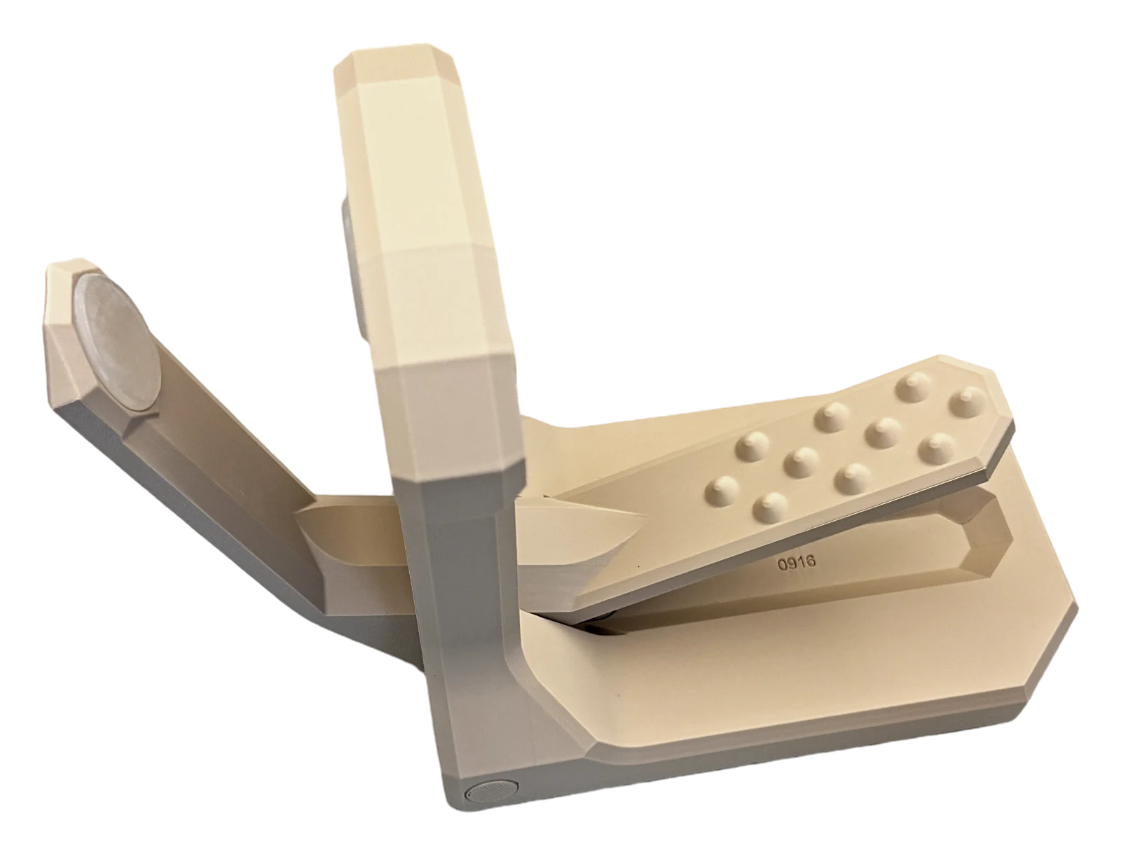 Cuffez from the side with its arm open: a flat base, an upright post, a gripper arm swung out to the left and a spiked pedal on the right.